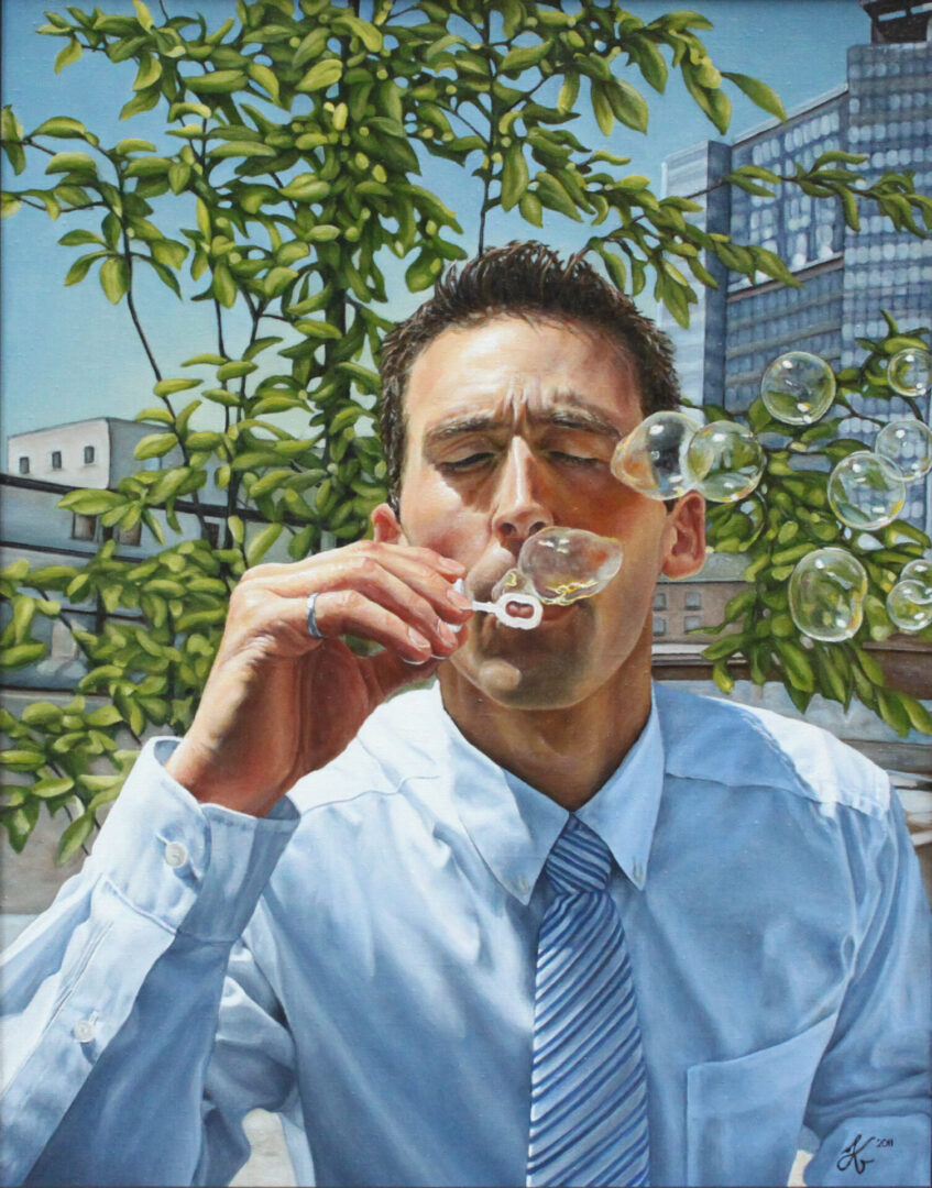 A man blowing bubbles in front of trees.