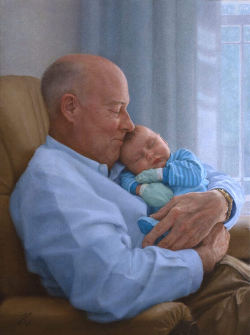 A man holding his baby in his arms.